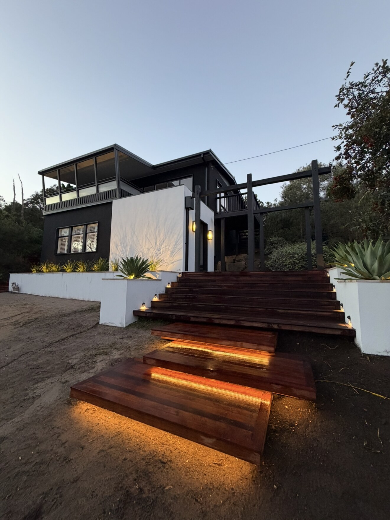 Outdoor timber stairs with warm lighting beneath the steps