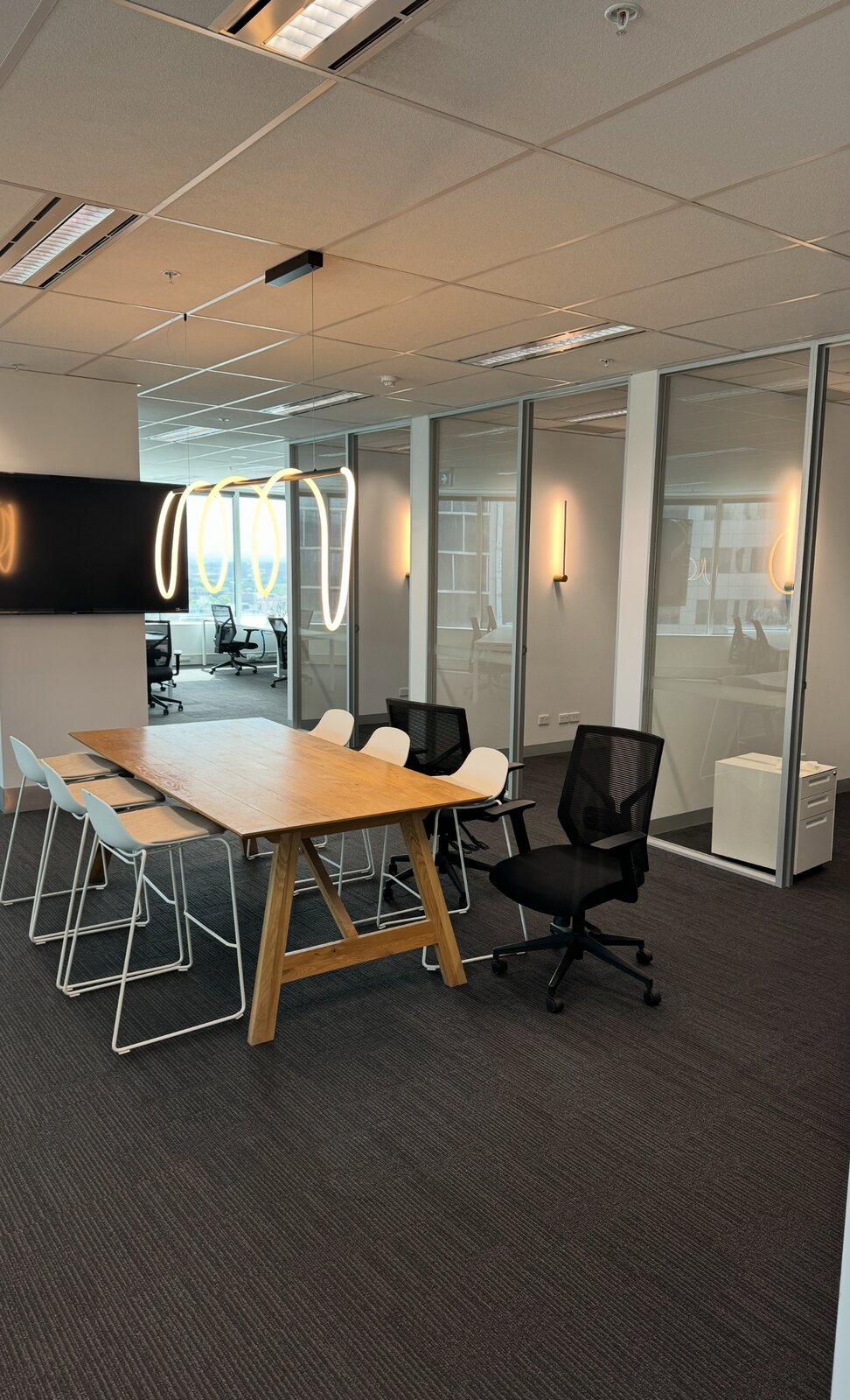 Pendant and wall lighting in a commercial office meeting space